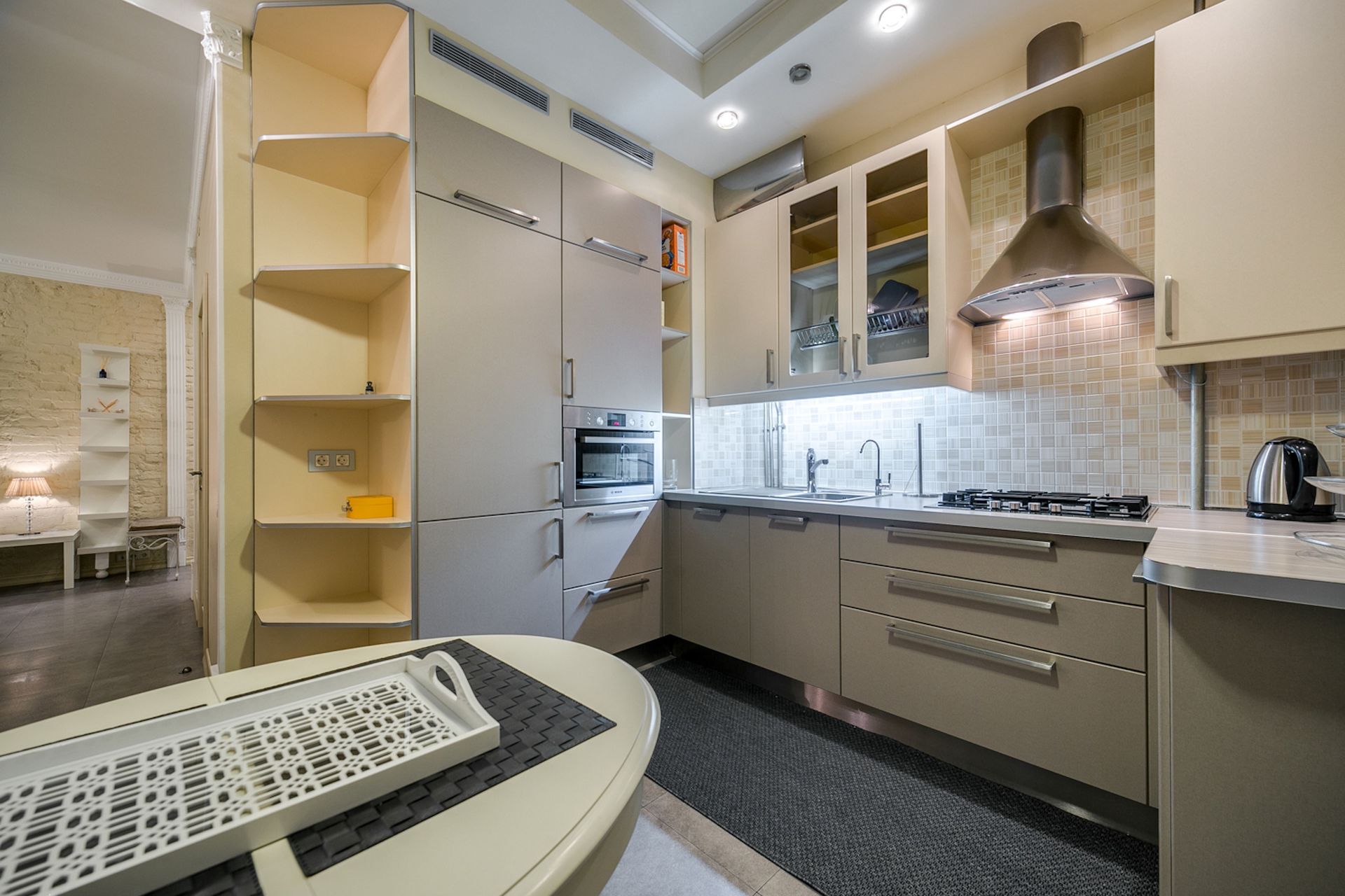 Sleek modern kitchen with neutral tones and stainless steel appliances.